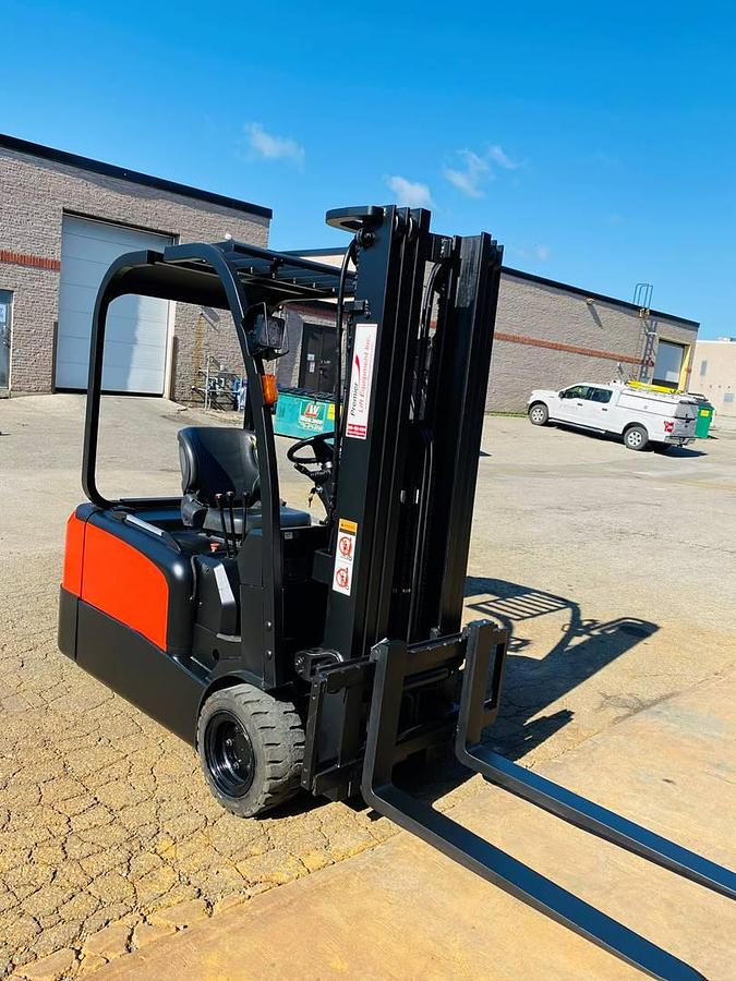 Front angled view of refurbished 2018 EP Equipment CPD20 3‑wheel electric forklift showing solid pneumatic tires, 3‑stage mast, battery compartment, and CSA certification decal during Brampton deployment.