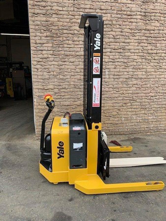 Side view of refurbished 2003 Yale MSW040 electric walkie straddle stacker showing mast rails, CSA decal, and 42" forks during Ontario deployment