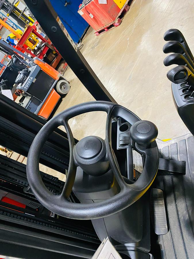 Steering wheel of Yale ERC065VG turret lift truck showing ergonomic grip, directional selector, and CSA-certified operator controls – unit staged in Brampton ON