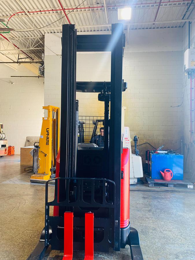 Front view of 2018 Raymond 750-R45TT reach truck showing triple-stage mast, carriage assembly, 42” forks, and 41” straddle legs – CSA certified electric forklift in Brampton ON