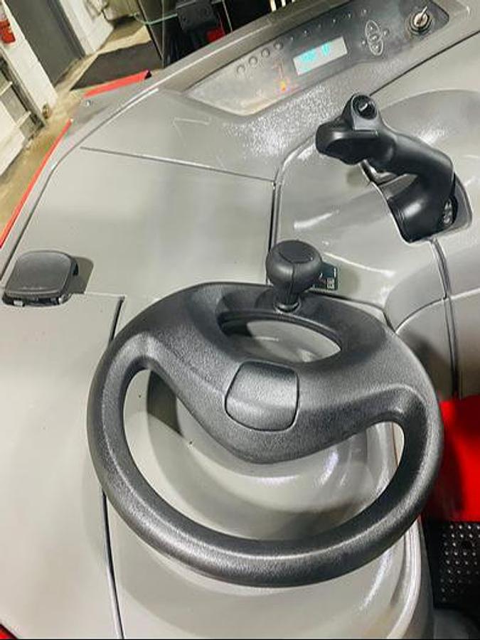 Operator view of refurbished 2014 Raymond 750-R45TT EE-rated reach truck showing steering wheel, joystick controls, and CSA decal during Ontario deployment