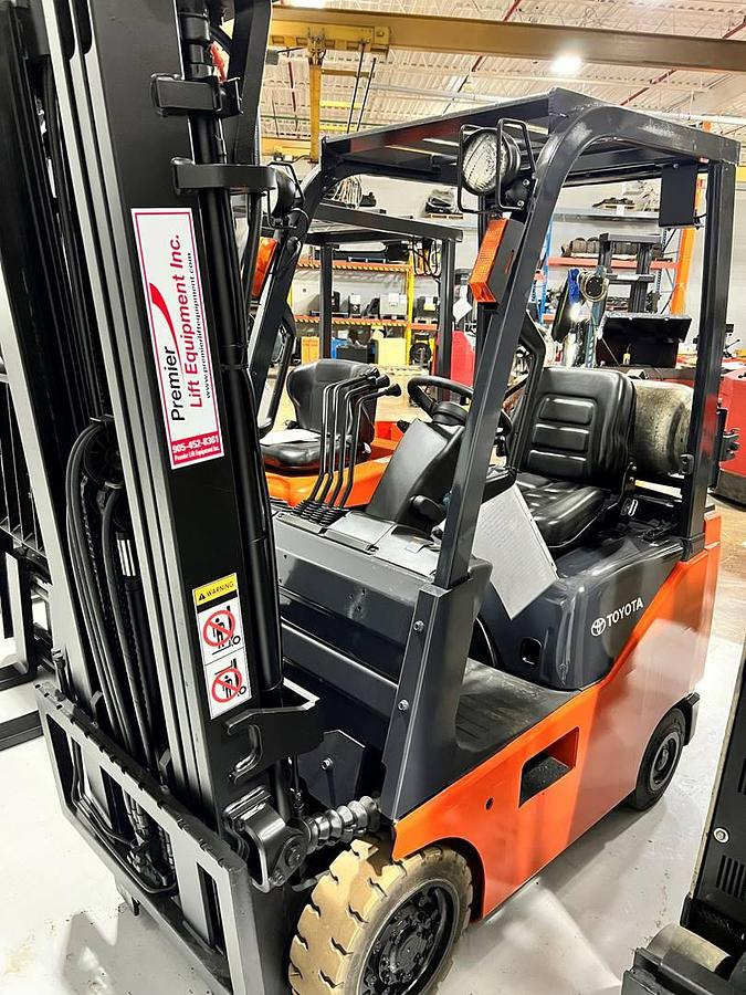 Opposite side view of refurbished 2007 Toyota 8FGCU15 LP gas forklift showing operator cab, rear chassis, and CSA decal during Brampton deployment