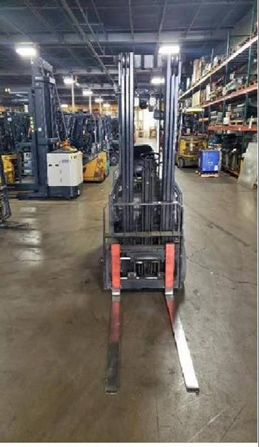 Head-on view of 2016 Toyota 8FBE18U electric forklift with forks lowered, triple mast extended, and CSA safety markings visible