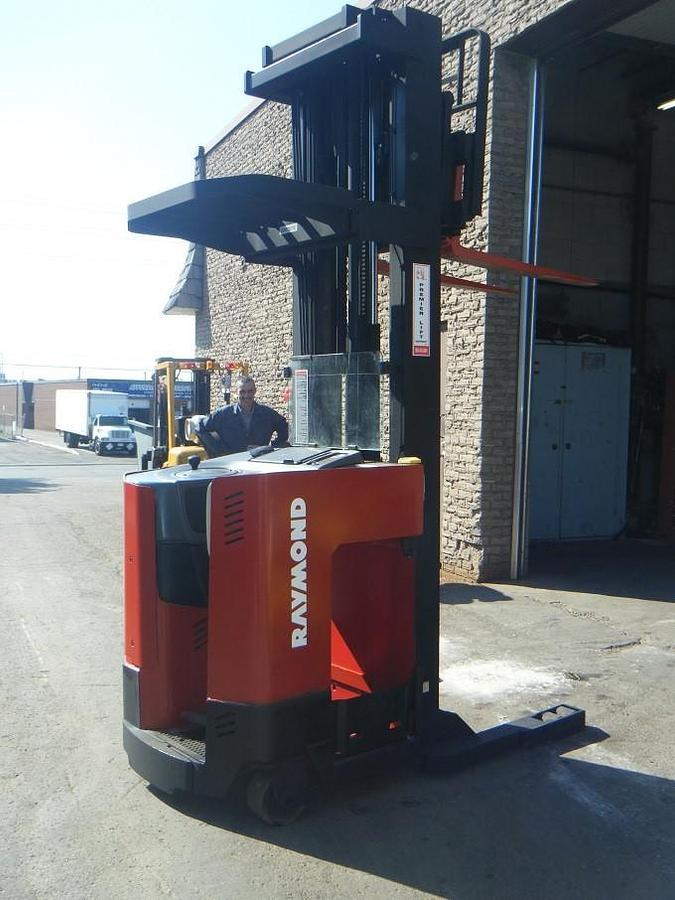 Opposite side view of refurbished 2010 Raymond EASIR40TT electric reach truck showing reach mechanism, drive unit cover, and chassis structure during Oakville deployment