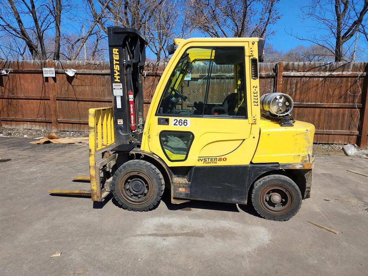 Side view of refurbished 2017 Hyster H80FT LP Gas forklift showing full cab, solid pneumatic tires, and 2‑stage mast with side shift during Ontario deployment.