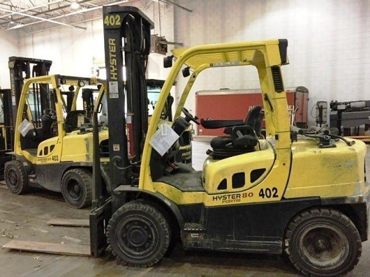 Front side angle of Hyster H80FT propane forklift showing 2-stage mast, side shifter, forks, pneumatic tires, and operator cab during Brampton deployment
