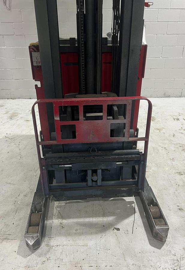 Close‑up view of Raymond EASI‑R45TT reach truck carriage showing load backrest, straddle legs, and integral sideshifter assembly.