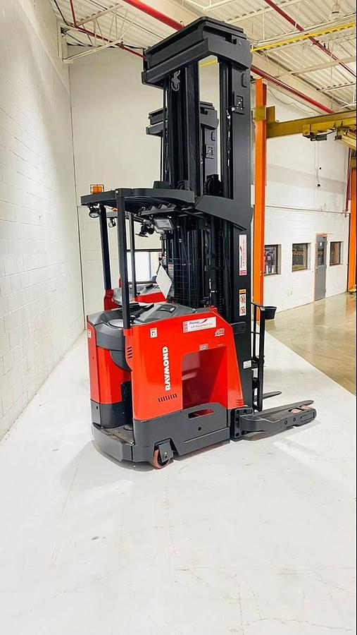 Angled shot of Raymond 752-R45TT reach trucks positioned for narrow aisle cold storage, highlighting freezer-rated poly tires, load backrests, and mast height – CSA certified in Brampton ON