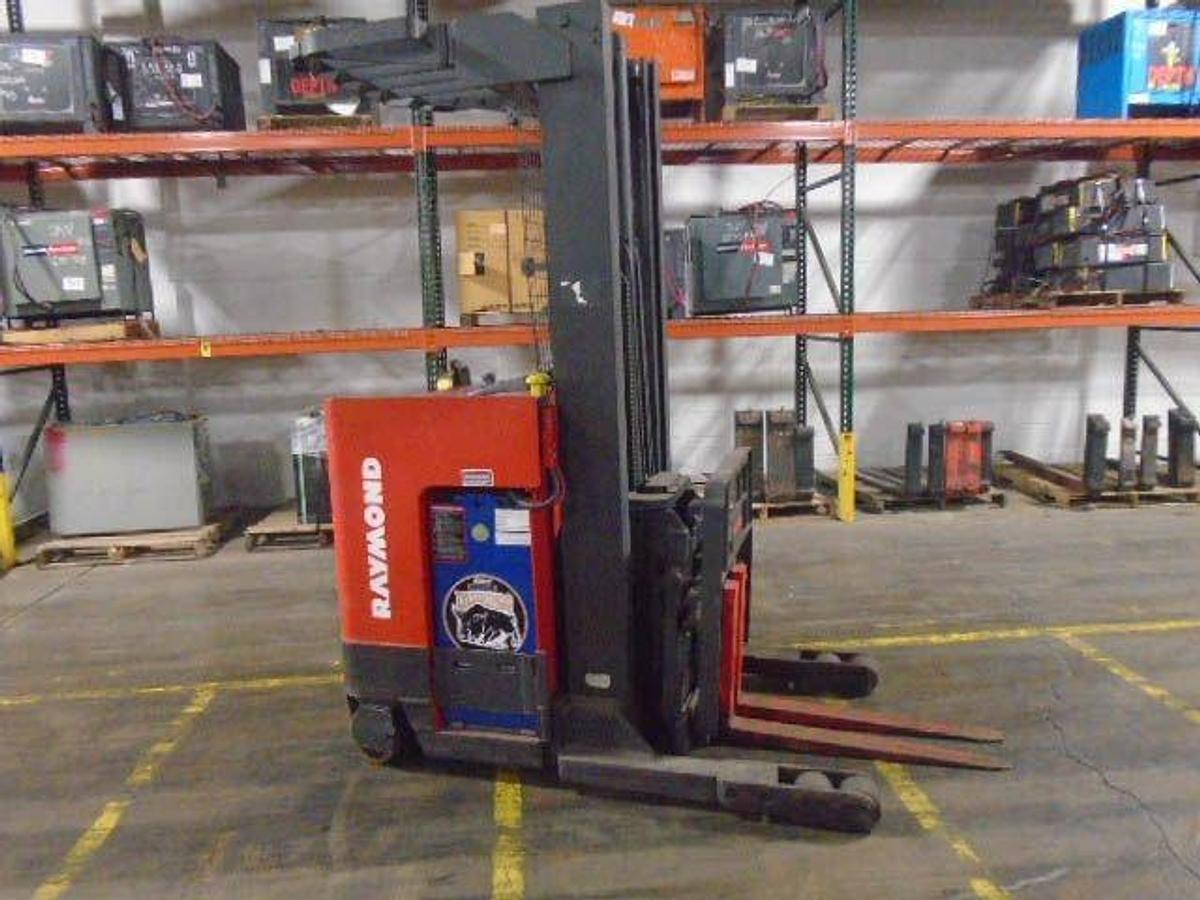 Side view of refurbished 1998 Raymond EASIR40TT electric reach truck showing chassis frame, battery compartment, and single reach carriage during Mississauga deployment