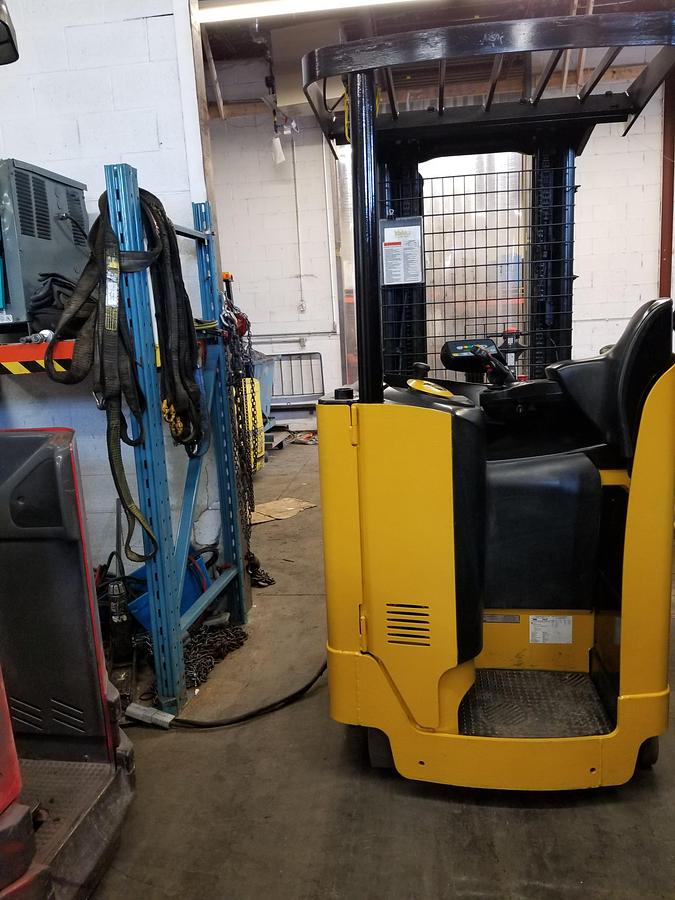 Back view of refurbished 2006 Yale NR040 electric reach truck showing counterweight, rear tires, and CSA certification decal during Ontario deployment
