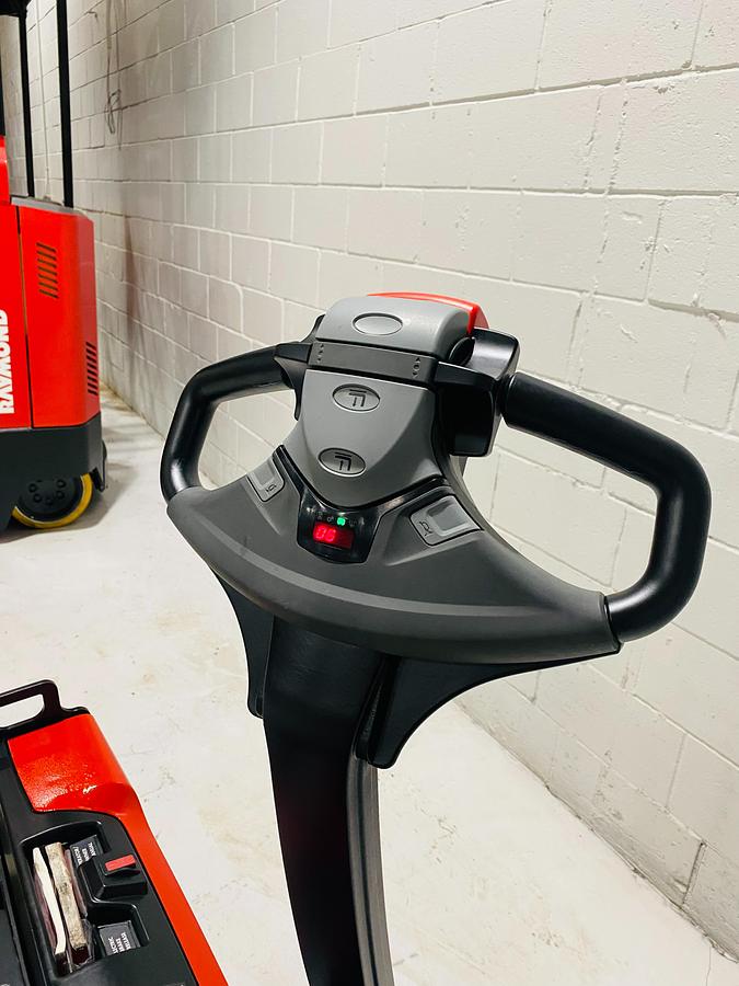 Operator handle and tiller arm controls on 2020 Raymond 8210 walkie pallet jack.