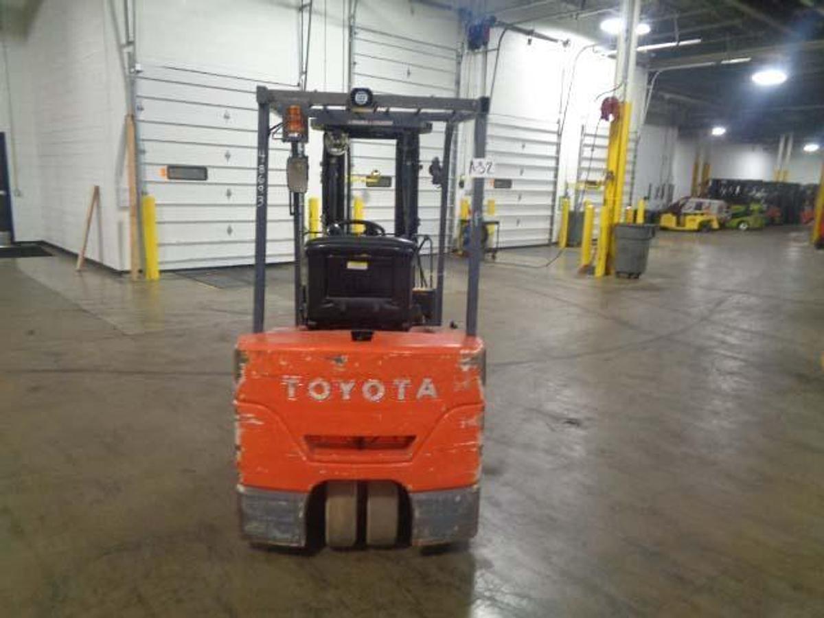 Rear view of Toyota 7FBEU20 electric forklift highlighting counterweight, safety decals, and CSA certification during warehouse deployment