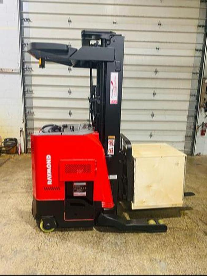 Side view of refurbished 2014 Raymond 750-R45TT EE-rated reach truck showing triple mast, CSA decal, and 41" base leg opening during Ontario deployment