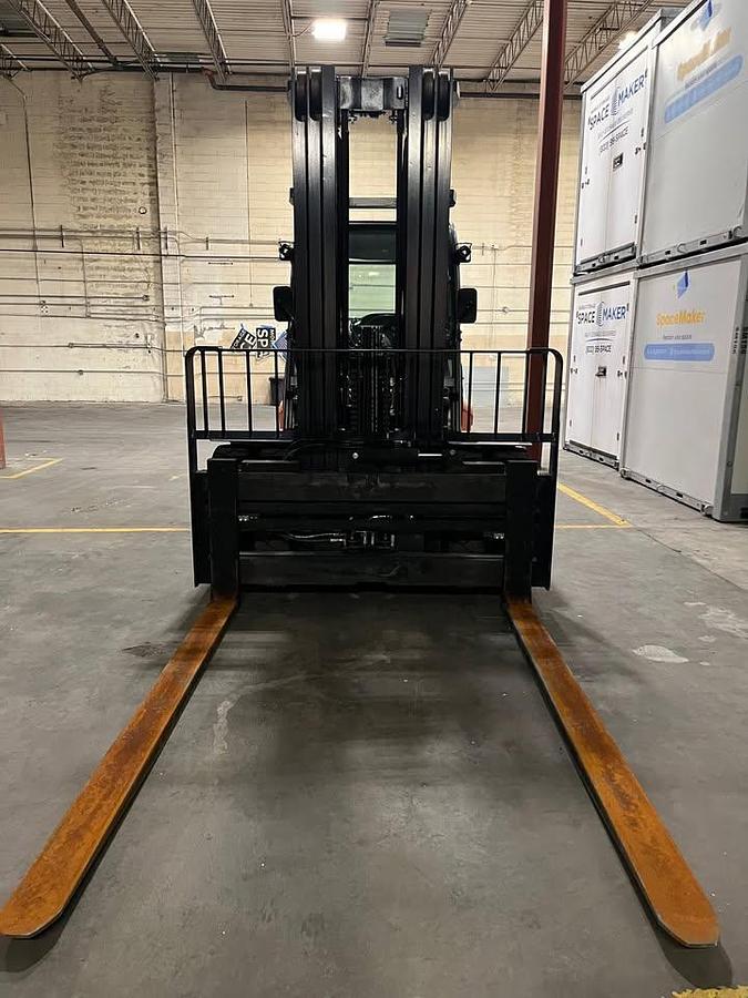 Front angled view showing mast rails and 96” fork tips