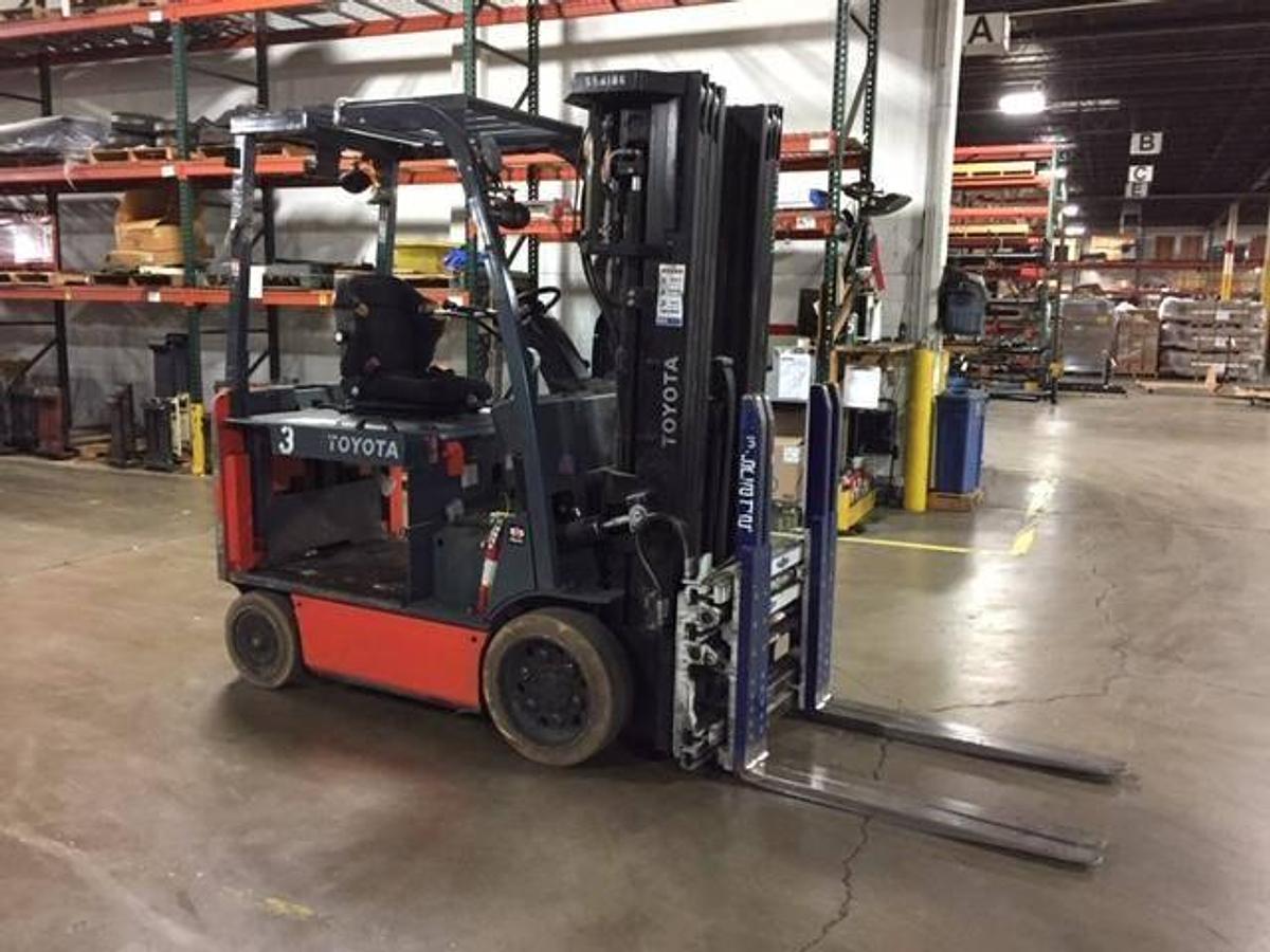 Opposite side view of refurbished 2016 Toyota 8FBCHU25 electric 4-wheel sit-down forklift showing 4-way hydraulic hoses, 48V battery box, and CSA decal during Ontario deployment