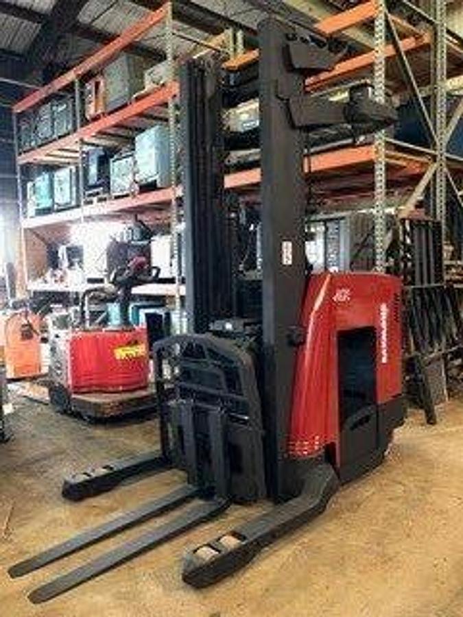 Front side angle of Raymond 740DR32TT deep-reach forklift showing 240" triple mast, reach carriage, directional wheels, and narrow aisle chassis during Brampton deployment