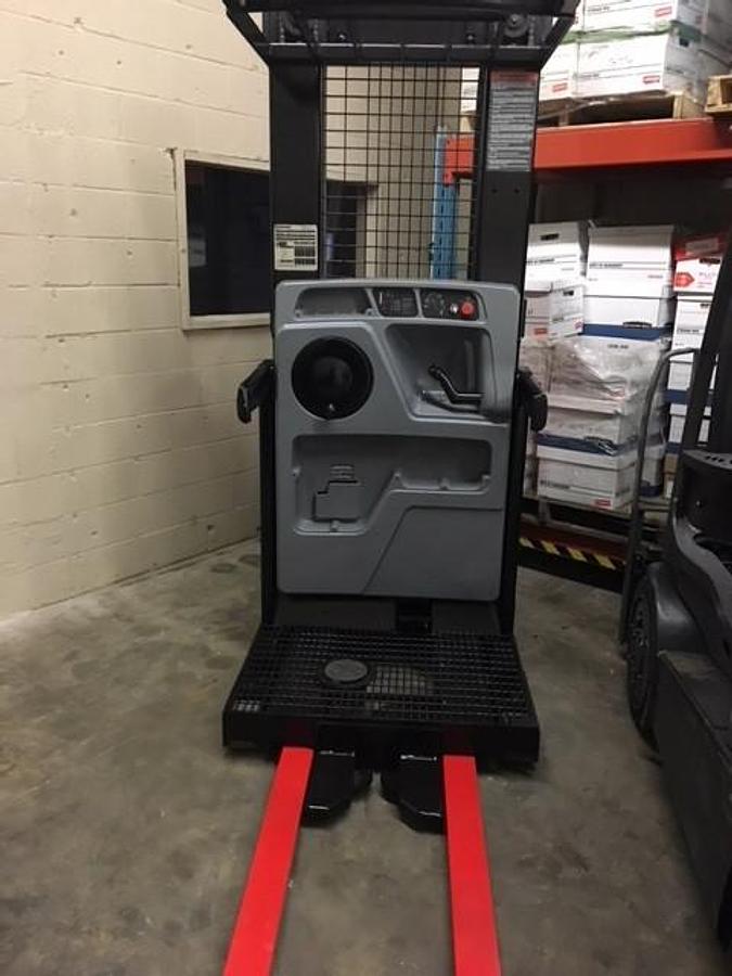 Interior view of refurbished 2006 Raymond 520-OPC30TT electric order picker showing operator controls, platform floor, safety rails, and CSA decals during Vaughan deployment