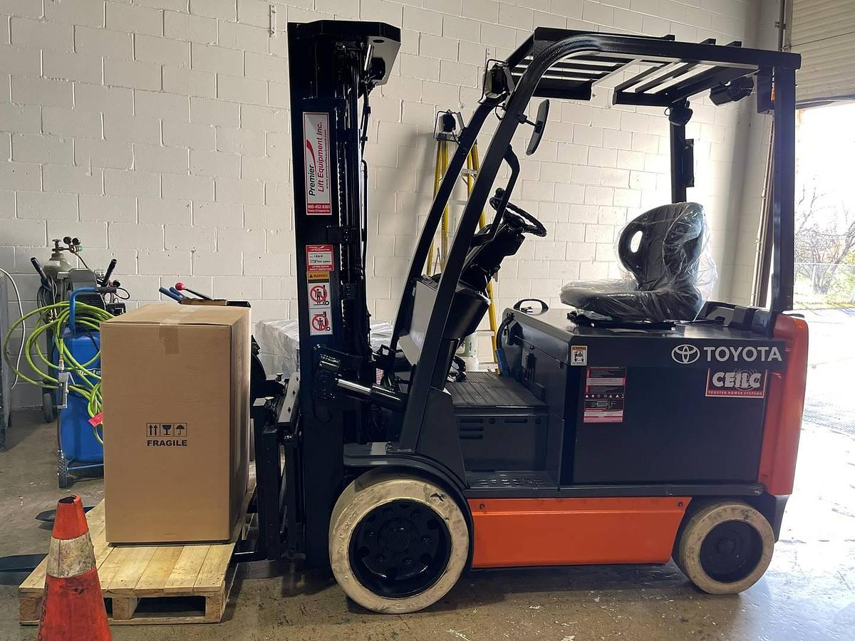 Opposite side view of 2018 Toyota 8FBCU30 electric forklift showing mast rails, CSA decals, and chassis profile during Brampton deployment