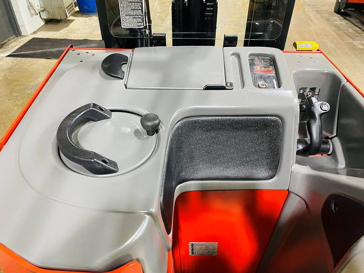 Interior view of vintage 1996 Raymond EASIR40TT electric reach truck showing operator controls, floor mat, safety rails, and CSA decals during Concord deployment