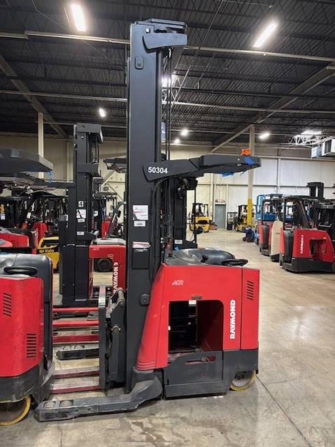 Side view of CSA-certified Raymond 750-DR32TT electric double reach truck with triple mast and cushion tires – staged in Brampton ON