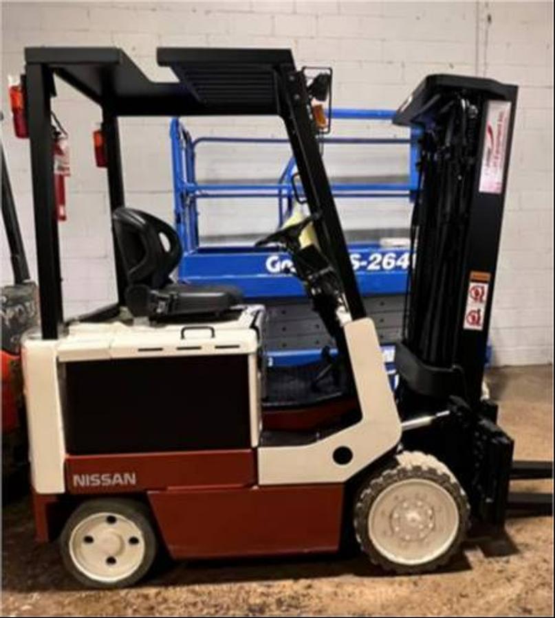 Side view of refurbished Nissan CWPG2L25S electric 4‑wheel forklift showing 48 volt chassis, 188" triple mast, no side shift, and CSA certification decal during Brampton deployment.