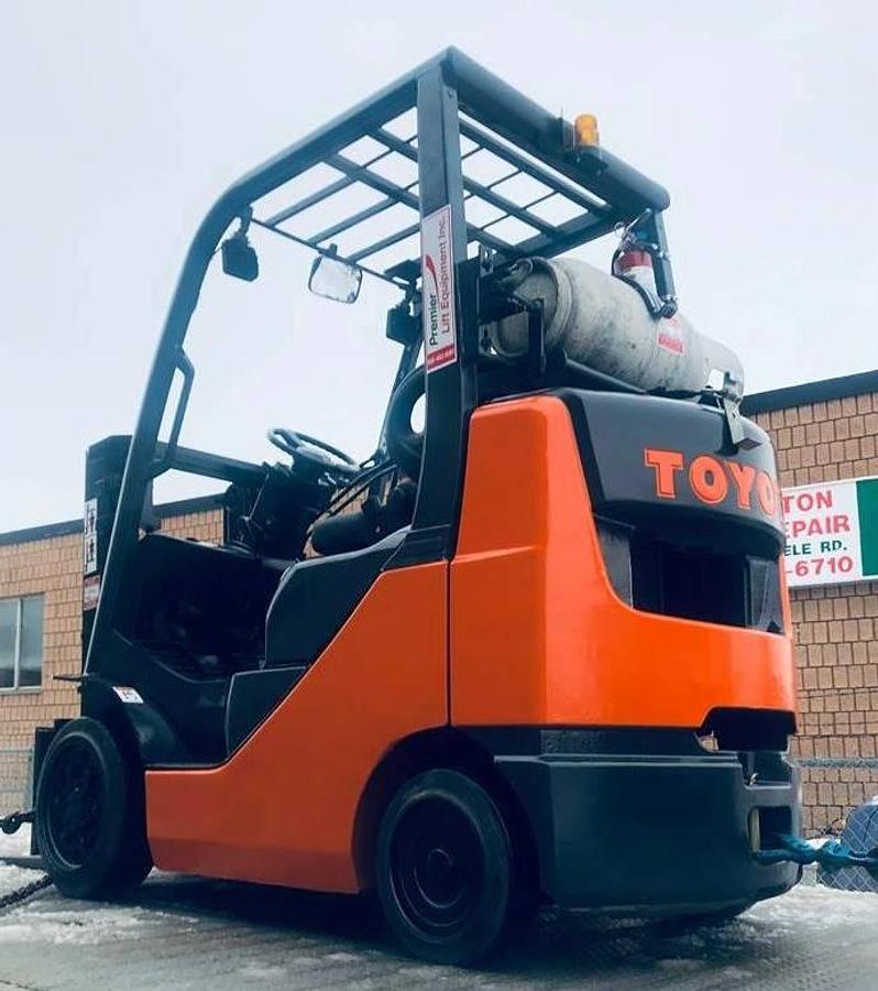 Rear view of refurbished 2013 Toyota 8FGCU25 LP gas forklift showing counterweight, propane tank mount, and CSA inspection tag during Brampton deployment