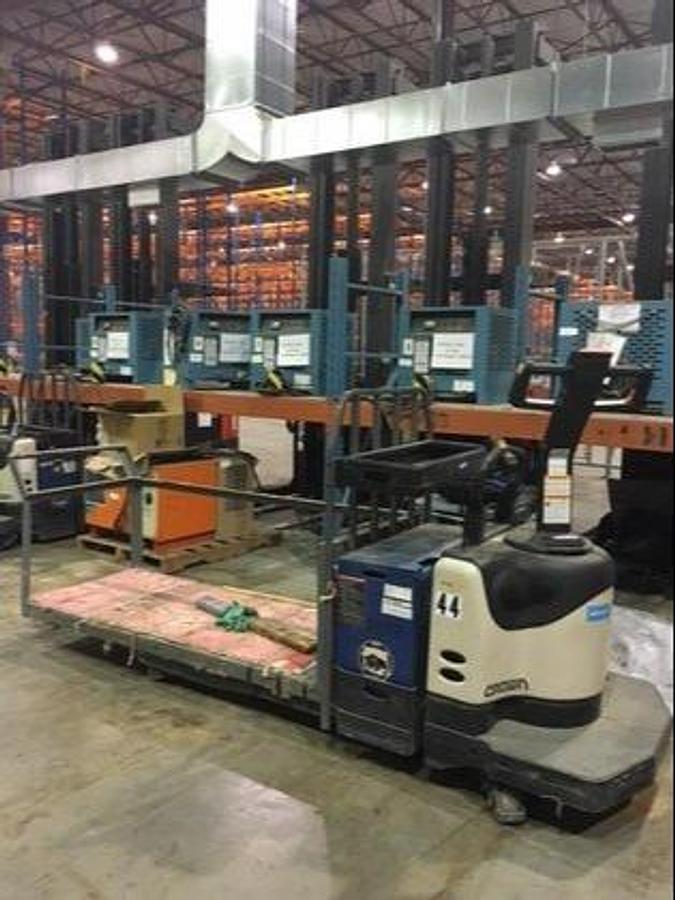 Side view of refurbished 2006 Crown PE400‑60 electric walkie/rider pallet jack showing 27" x 48" forks, work platform, and CSA certification decal during Ontario deployment.