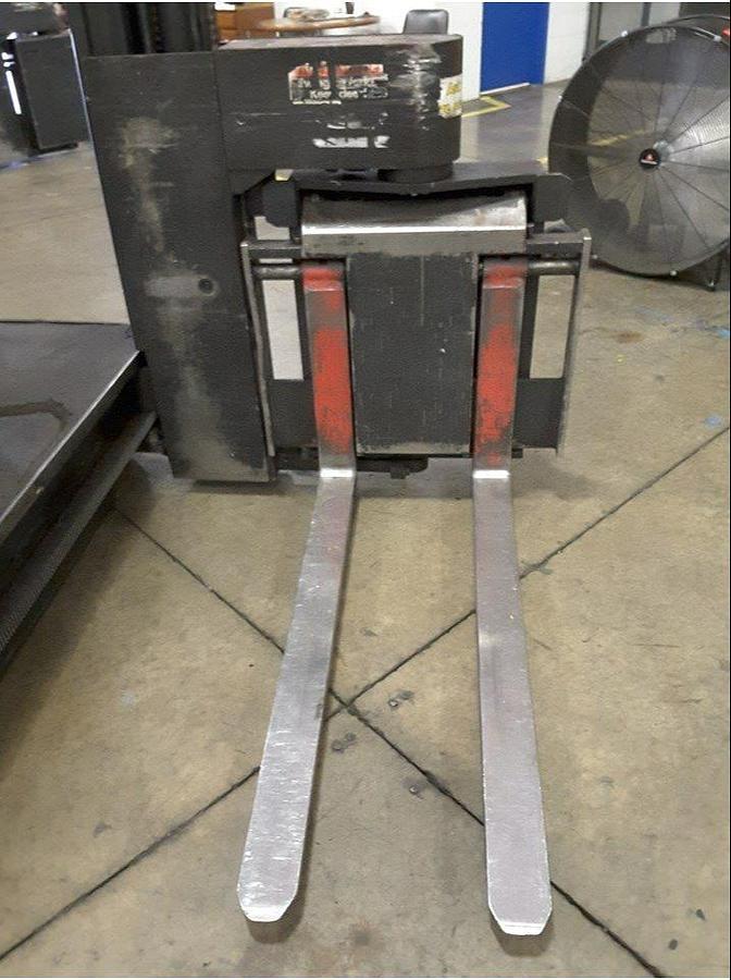 Front view of refurbished 2012 Raymond 960-CSR30TT electric man-up turret truck showing mast articulation, fork carriage, and swing reach turret during Ontario deployment