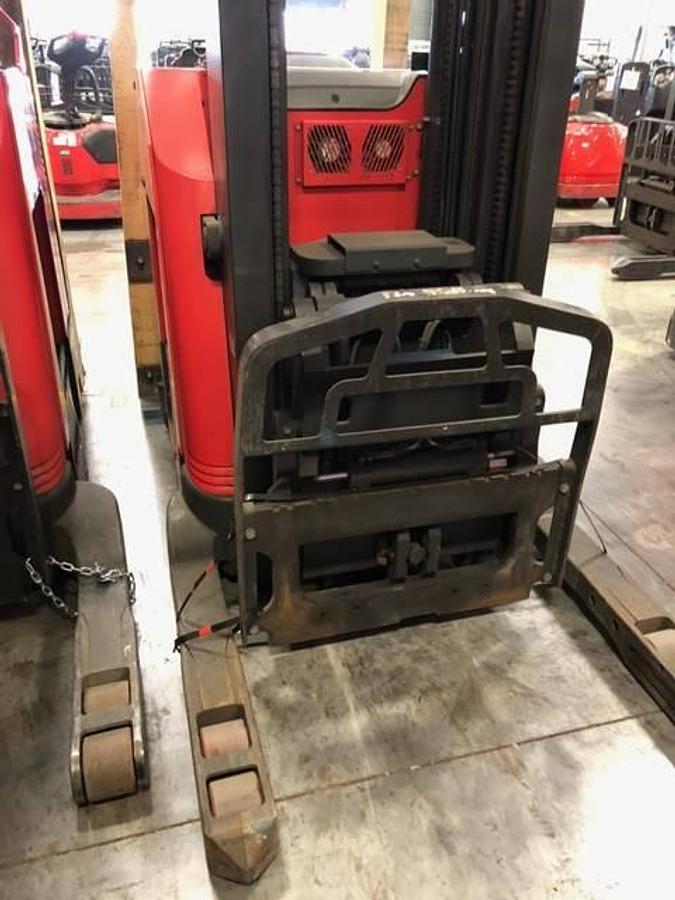 Head-on view of refurbished 2014 Raymond 750DR32TT electric deep-reach forklift showing 348" triple mast, forks, base legs, and operator cab with CSA safety decals during Brampton deployment