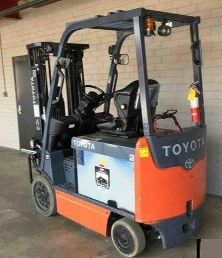 Opposite rear angle side view of refurbished 2015 Toyota 8FBCHU25 electric 4-wheel sit-down forklift showing battery compartment, safety lights, and rear frame during Ontario deployment