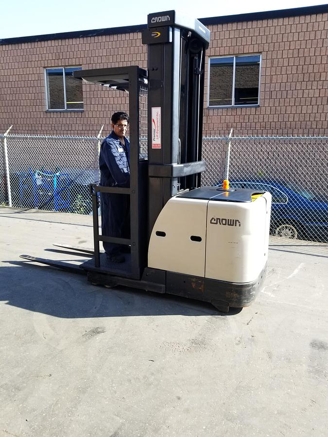 Wire‑guided Crown SP3520‑30 forklift staged for narrow‑aisle warehouse operations