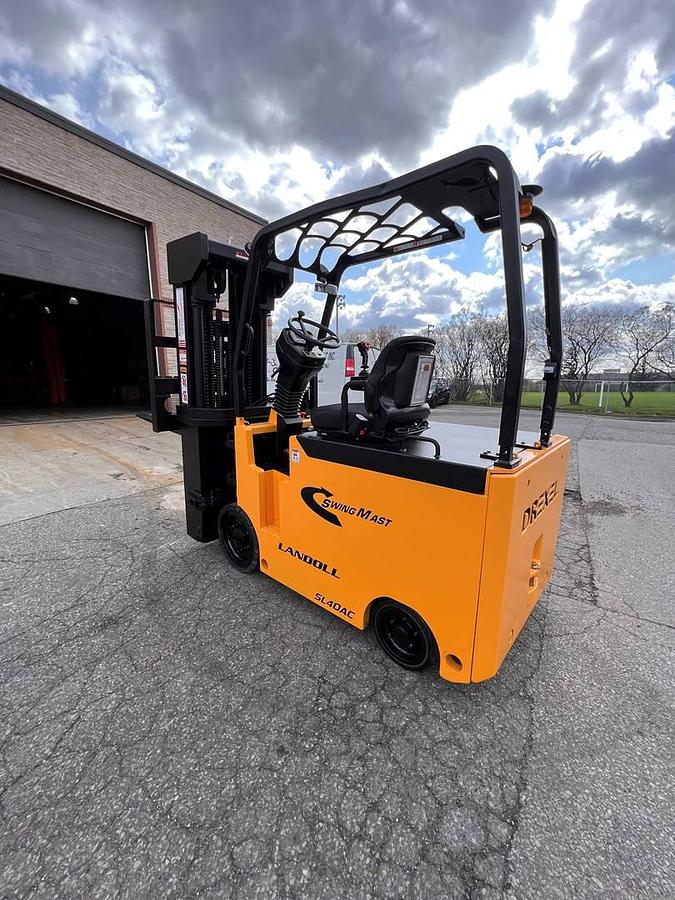 Rear side angle of Drexel SL-40AC SwingMast forklift showing counterweight, rear wheels, and CSA certification during warehouse deployment