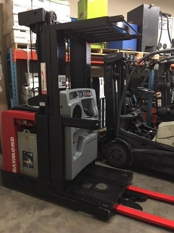 Front angle view of refurbished 2006 Raymond 520-OPC30TT electric order picker showing mast, forks, platform, and CSA inspection tag during Vaughan deployment
