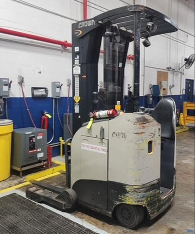 Side angle of Crown RR5725-45 electric reach truck – narrow aisle profile, EE rated, CSA compliant with battery installed