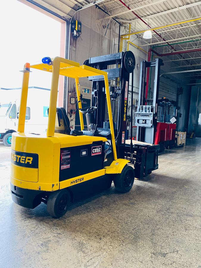 Rear side view showing rear chassis, new 48V battery compartment, Superior Swing Attachment, and CSA certification decal during Ontario deployment.
