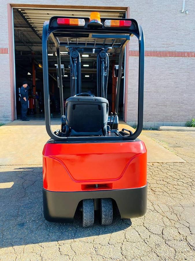 Back view of refurbished 2018 EP Equipment CPD20 3‑wheel electric forklift showing rear chassis, counterweight, battery compartment, solid pneumatic tires, and CSA certification decal during Brampton deployment.