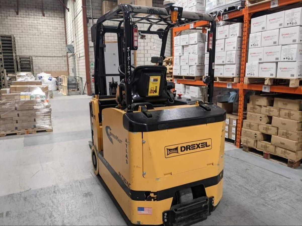 Rear view of Drexel SLT30AC SwingMast forklift showing counterweight, operator cab, and CSA certification during warehouse deployment