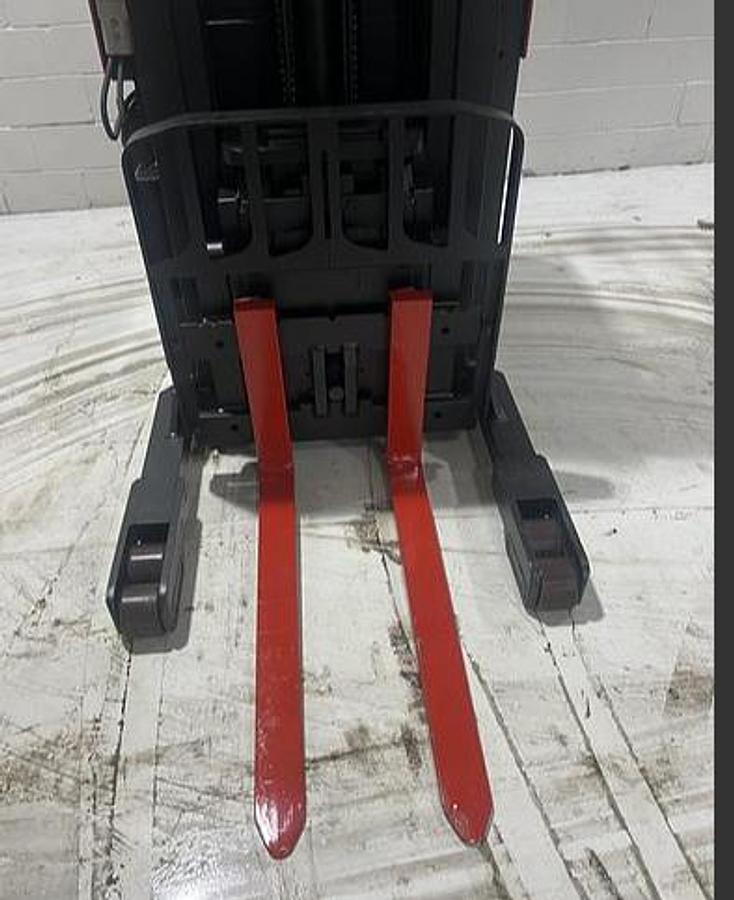 Close‑up of 42” forks and straddle legs on Raymond 31I‑R45TT single‑reach truck — Budget indoor electric unit.