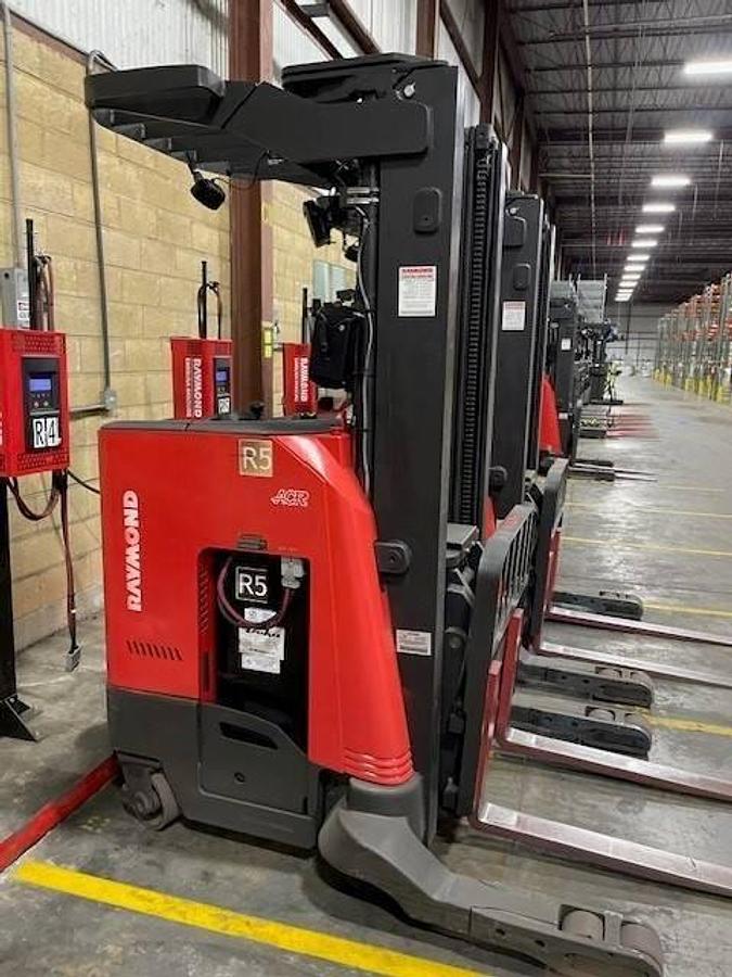 Side view of refurbished 2020 Raymond 730-R35TT electric reach truck showing battery compartment, chassis frame, and 42" base legs during Brampton deployment