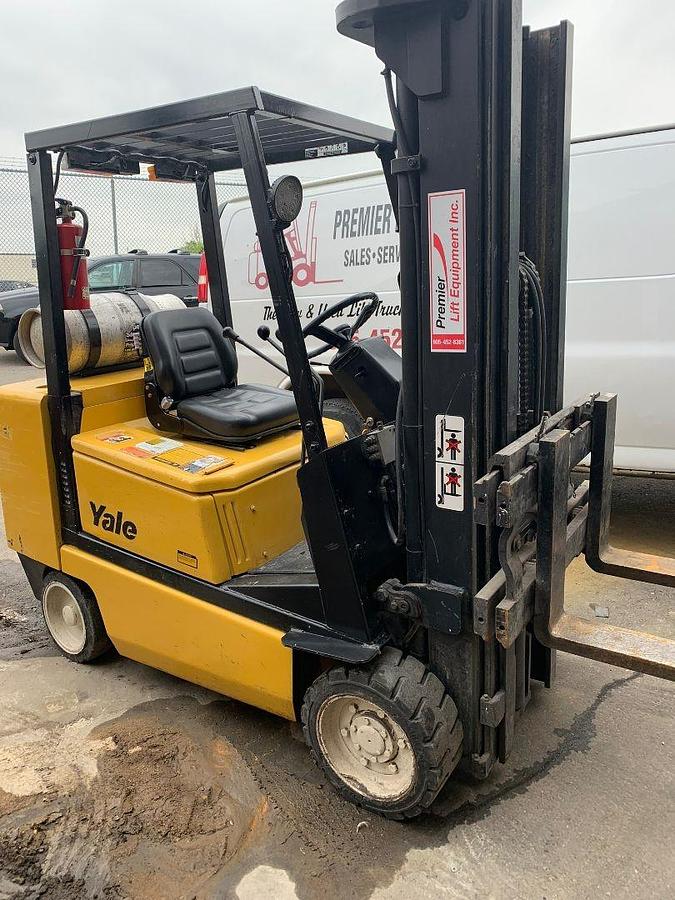 Front side angle of Yale GLC050DEJUA083 LPG cushion forklift showing triple mast, side shift carriage, and cushion tires during Brampton deployment
