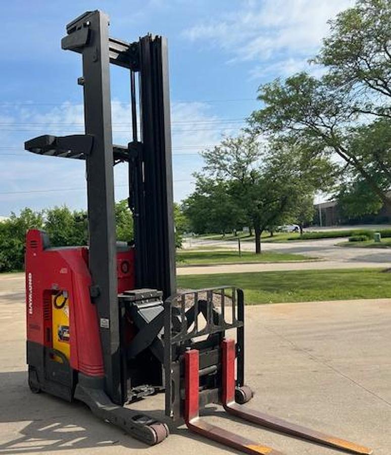 Opposite side front angle view of 2020 Raymond 750-R45TT electric reach truck with carriage fully extended – CSA-certified 4,500 lb unit featuring 301” triple mast, 42” forks with side shift, ergonomic operator station, and 36V AC chassis staged in Brampton ON; shown chassis only without battery or charger, available separately as extra options new or used – Premier Lift Equipment