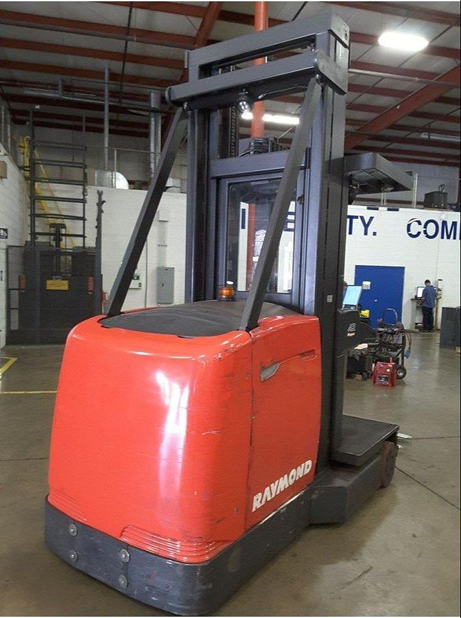 Rear angle side view of refurbished 2012 Raymond 960-CSR30TT electric man-up turret truck showing operator platform, control panel, and rear chassis during Ontario deployment
