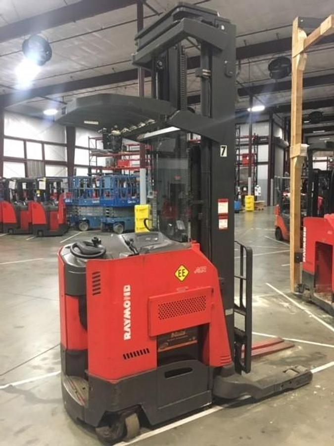 Side view of refurbished 2011 Raymond 740-R45TT EE-rated electric reach truck showing battery compartment, dockstance cab, and chassis frame during Concord deployment