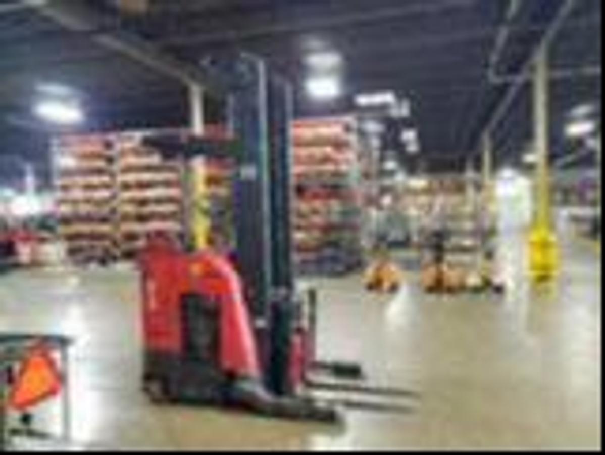 Pre-refurbishment image of 2016 Raymond 750-R45TT electric reach truck prior to CSA certification and repainting, later deployed in Mississauga