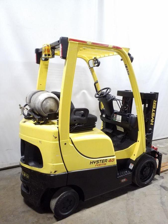 Rear side view of refurbished 2014 Hyster S40FT LP Gas forklift showing rear chassis, solid black tires, headlights, and CSA certification decal during Ontario deployment.