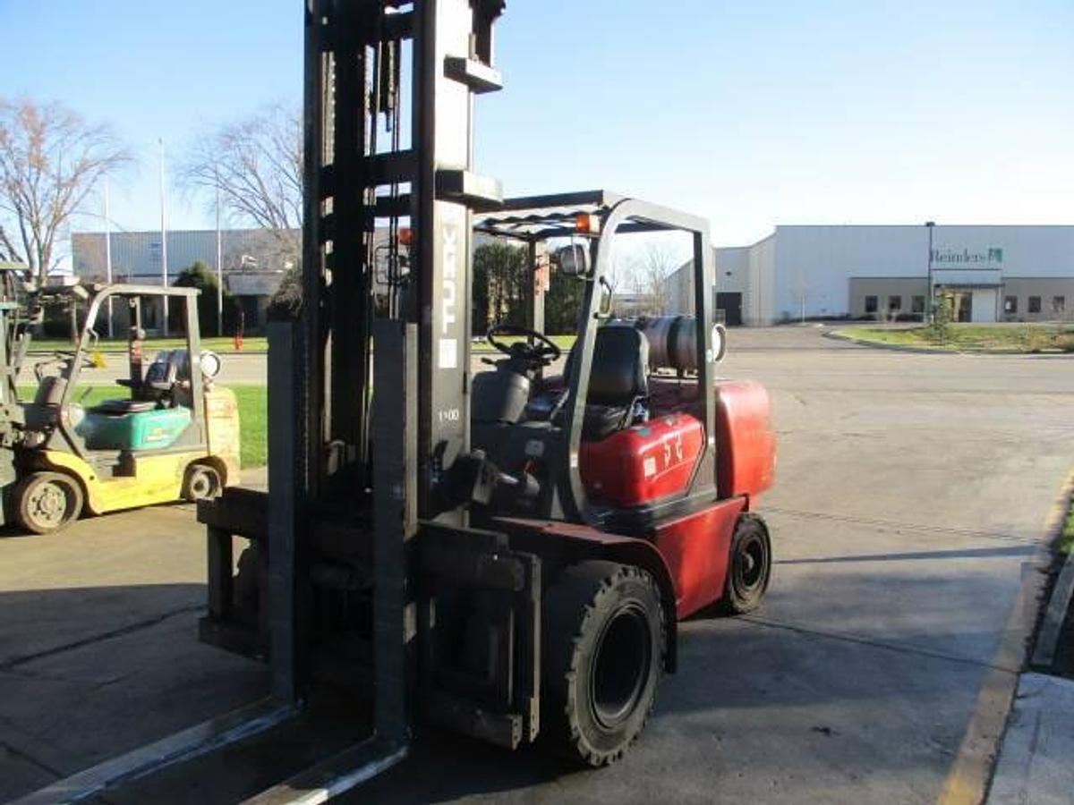 Alternate front angle view of 2008 Tusk 1100PGA2-8 propane forklift showing 2-stage mast, extended forks, dual solid pneumatic tires, and CSA-certified chassis – unit staged in Brampton ON