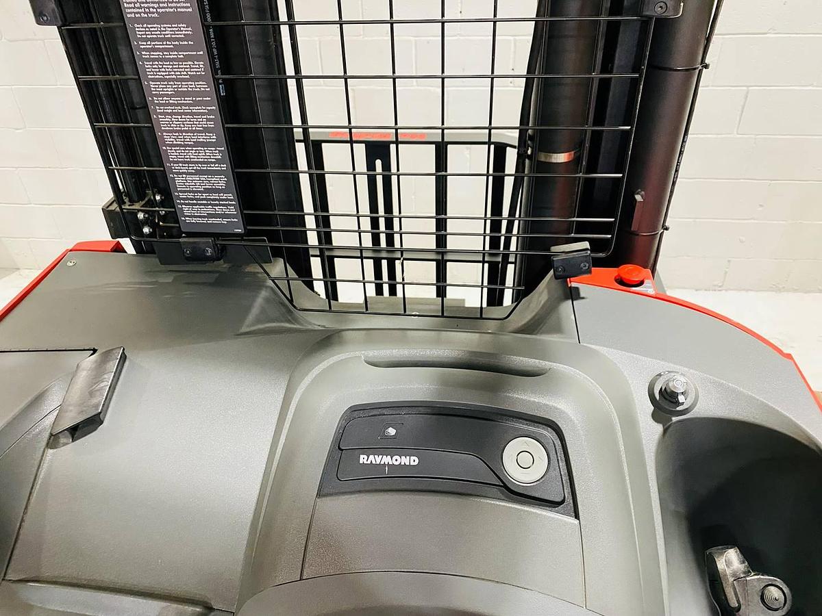 Operator dash of 2022 Raymond 752 DR32TT electric deep-reach forklift showing steering wheel, instrument panel, and CSA safety decals during Brampton deployment