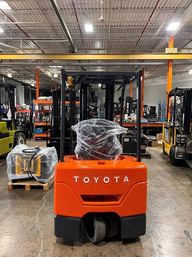 Rear view of 2013 Toyota 7FBEU20 electric forklift showing counterweight profile, rear cushion tires, and three-wheel configuration – CSA-certified chassis staged in Brampton ON