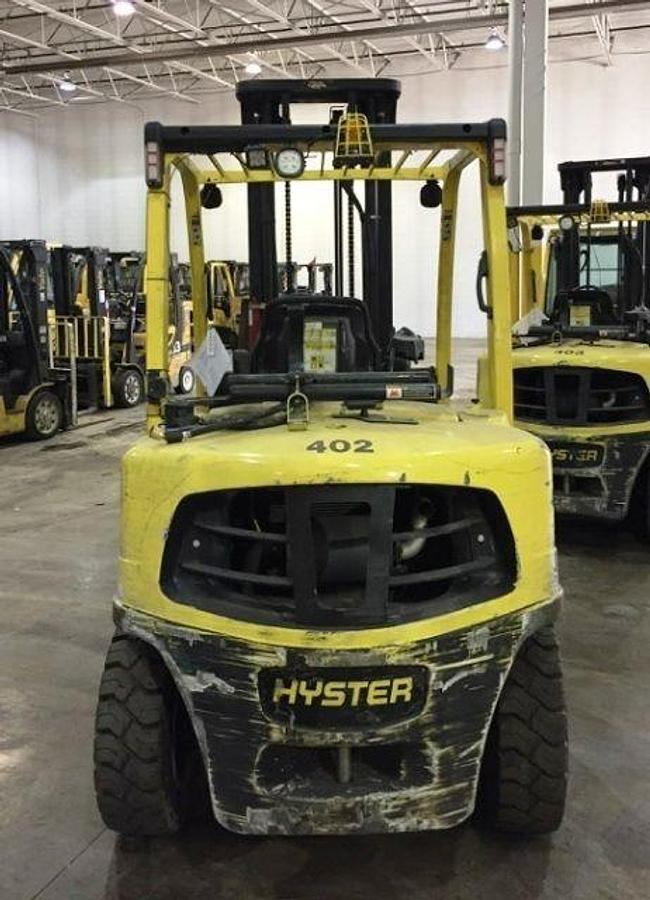 Rear view of refurbished 2013 Hyster H80FT propane forklift showing counterweight, rear tires, and propane tank bracket during Brampton deployment