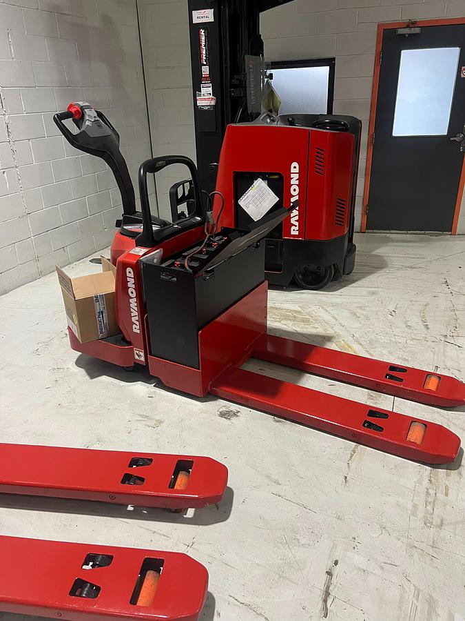 Side view of Budget Raymond 8400 walkie pallet jack, older non‑CSA unit with 27×48 forks.